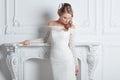 Beautiful bride in a wedding dress standing in a chic hotel room Royalty Free Stock Photo