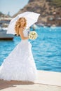 Beautiful bride in wedding dress with white umbrella, outdoors p Royalty Free Stock Photo