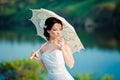 Beautiful bride in wedding dress with white umbrella, outdoors portrait Royalty Free Stock Photo
