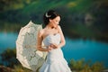 Beautiful bride in wedding dress with white umbrella, outdoors portrait Royalty Free Stock Photo