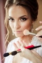 Beautiful bride wedding makeup and hair-style. Stylist makes makeup bride on wedding day. Royalty Free Stock Photo