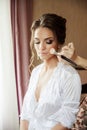 Beautiful bride wedding makeup and hair-style. Stylist makes makeup bride on wedding day.