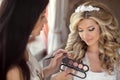 Beautiful bride wedding with makeup and hairstyle. Stylist makes Royalty Free Stock Photo