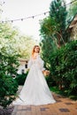 beautiful bride in a white delicate dress on the path in the park.