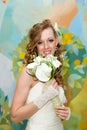 Beautiful bride in a white dress with a bouquet of calla lilies Royalty Free Stock Photo