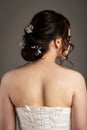 Bride in white dress with bouquet in photostudio