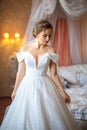 Beautiful bride in white dress in hotel room