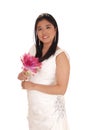 Beautiful bride in a white wedding dress with a lily