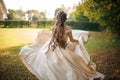 Beautiful bride in a white wedding dress running in the park Royalty Free Stock Photo
