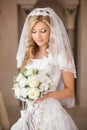 Beautiful bride woman with bouquet of flowers, wedding makeup an Royalty Free Stock Photo