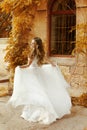 Beautiful bride woman in white wedding dress running at autumn p Royalty Free Stock Photo
