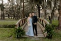 Beautiful Bridesmaid Woman in Blue Dress and Bouquet with Her Date at a Formal Wedding Party Celebration Event Outside in the Wood