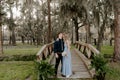 Beautiful Bridesmaid Woman in Blue Dress and Bouquet with Her Date at a Formal Wedding Party Celebration Event Outside in the Wood