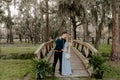 Beautiful Bridesmaid Woman in Blue Dress and Bouquet with Her Date at a Formal Wedding Party Celebration Event Outside in the Wood