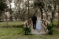 Beautiful Bridesmaid Woman in Blue Dress and Bouquet with Her Date at a Formal Wedding Party Celebration Event Outside in the Wood