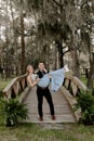 Beautiful Bridesmaid Woman in Blue Dress and Bouquet with Her Date at a Formal Wedding Party Celebration Event Outside in the Wood