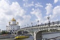 beautiful bridge and orthodox cathedral of christ saviour with a touristic boat under the bridge