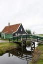 Beautiful Bridge over a Canal with a Traditional Building in Zaanse Schans Netherlands
