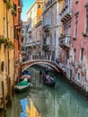 Beautiful bridge over a small canal lined, on colorful building background, Venice, Italy, during Lockdown Crisis COVID-19