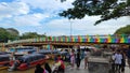 Beautiful bridge with rainbow colored paint over the Martapura river with boats anchored in the city of Banjarmasin