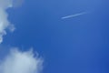 Beautiful bright blue sky with with a flying plane. clouds. picturesque colorful