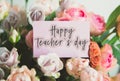 Bright bouquet of colorful roses with pink card with the inscription happy teacher s day, concept of congratulations Royalty Free Stock Photo