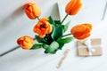 A beautiful bright bouquet of orange tulips. Craft envelopes