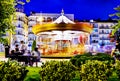 Beautiful bright carousel at night. Amusement park of the city in winter. Royalty Free Stock Photo