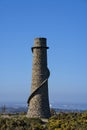 Beautiful bright close-up vertical view of Ballycorus lead mining and smelting chimney tower against perfectly clear blue sky