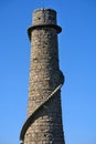 Beautiful bright close-up vertical view of Ballycorus lead mining and smelting chimney tower against perfectly clear blue sky