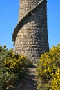 Beautiful bright close-up vertical view of Ballycorus lead mining and smelting chimney tower and trail in wild yellow gorse