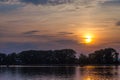 Beautiful bright cloudy sunset above the lake. Royalty Free Stock Photo