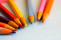 Beautiful bright colored wooden colored sharpening pencils for drawing. Flat lay and copy space on blue background Royalty Free Stock Photo