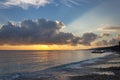 Beautiful bright dawn with colored clouds in the sky over the sea, ocean. Sandy coastline, beach, lush clouds. Summer tropical Royalty Free Stock Photo