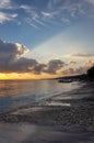 Beautiful bright dawn with colored clouds in the sky over the sea, ocean. Sandy coastline, beach, lush clouds. Summer tropical Royalty Free Stock Photo