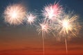 Beautiful bright fireworks lighting up twilight sky outdoors Royalty Free Stock Photo