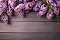 Beautiful bright lilac flowers on wooden background, closeup