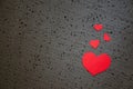 Beautiful bright red heart on a rough black background. A symbol of love and valentines day background. Royalty Free Stock Photo