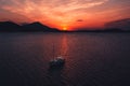 Beautiful bright red sunset sky over a sea with a boat in Chalkida, Greece Royalty Free Stock Photo