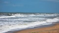 Beautiful bright sea with waves splashing and beach sand of Bay of Bengal at Odisha, Puri Royalty Free Stock Photo