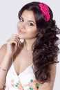 Beautiful bright smiling a soft, sweet girl with long black curly hair with a wreath of flowers in hair in summer white sundress Royalty Free Stock Photo