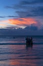 Beautiful bright sunset with colored clouds in the sky over the sea, ocean. Silhouette boat in the sea, lush clouds. Summer Royalty Free Stock Photo