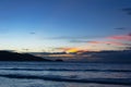 Beautiful bright sunset with colored clouds in the sky over the sea, ocean. Silhouette boat in the sea, lush clouds. Summer Royalty Free Stock Photo