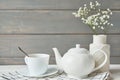 Beautiful bright tea set up. White ceramic tea pots and tea ingredients, on top of the white table. Copy Space. Spring Greeting Royalty Free Stock Photo