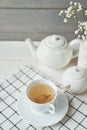 Beautiful bright tea set up. White ceramic tea pots and tea ingredients, on top of the white table. Copy Space. Spring Greeting Royalty Free Stock Photo