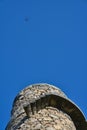 Beautiful bright vertical upward view of Ballycorus lead mining and smelting chimney tower and flying drone against clear blue sky