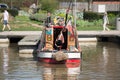 Beautiful brightly coloured canal barge narrowboat moored in canal basin on sunny day in UK