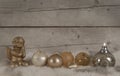 Beautiful bronze and golden glass christmas baubles and candle and angel, on sheepskin