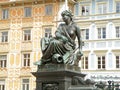 Beautiful bronze statue with the pastel colored buildings at the main square of Glaz