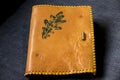 Beautiful brown artisan leather notebook with braided decorated with an oak leaf